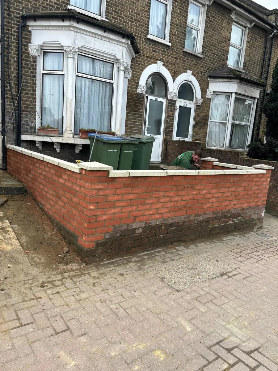 Block paved front garden and brick wall