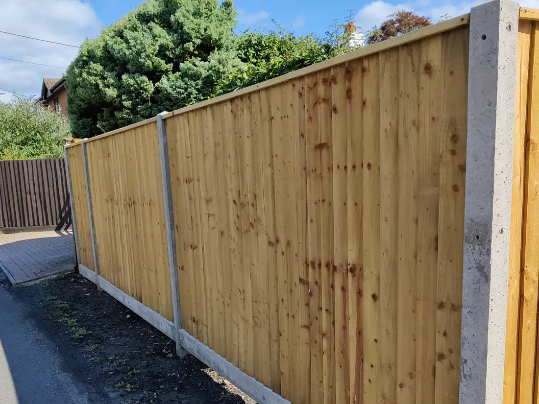 Featherboard fencing with concrete posts